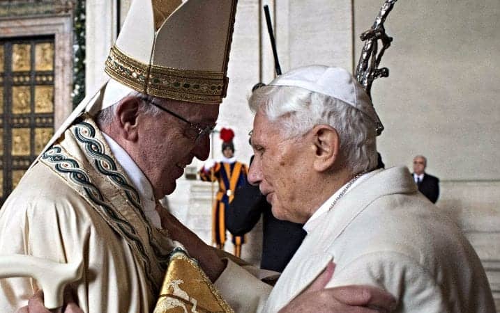 Pope Francis greeted retired Pope Benedict XVI before opening the Holy Door in St. Peter's Basilica at the Vatican Dec. 8, 2015. (CNS photo / L'Osservatore Romano, handout via EPA)