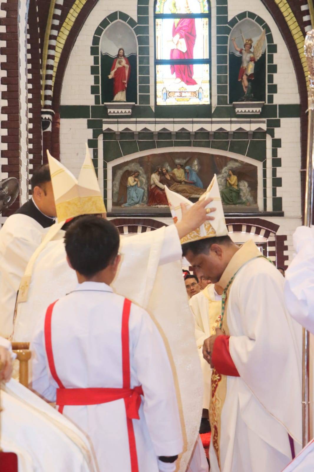 Cardinal Charles Bo puts miter on Bishop Raymond Wai Lin Htun on March 19, 2025 in Yangon, Myanmar. (Credit: Archdiocese of Yangon.)