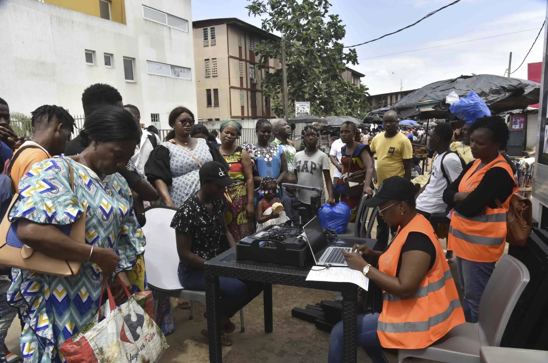 Residents line up in front of an enrollment center in Abidjan, Ivory Coast, on June 10, 2014. (Credit: Diomande Ble Blonde/AP.)