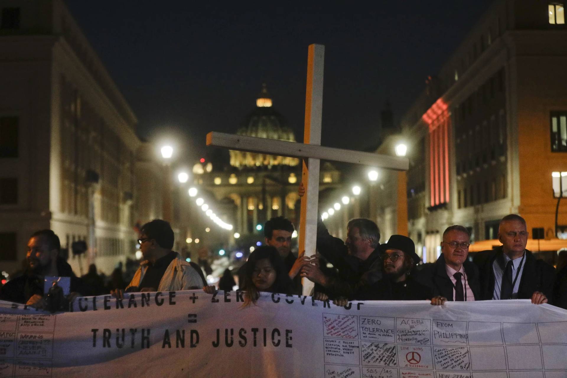 Survivors of sex abuse hold a cross as they gather in front of Via della Conciliazione, the road leading to St. Peter’s Square, visible in background, during a twilight vigil prayer of the victims of sex abuse, in Rome, Thursday, Feb. 21, 2019. Five years ago this week, Francis convened an unprecedented summit of bishops from around the world to impress on them that clergy abuse was a global problem and they needed to address it, but now, five years later, despite new church laws to hold bishops accountable and promises to do better, the Catholic Church’s in-house legal system and pastoral response to victims has proven again to be incapable of dealing with the problem. (Credit: Gregorio Borgia/AP.)